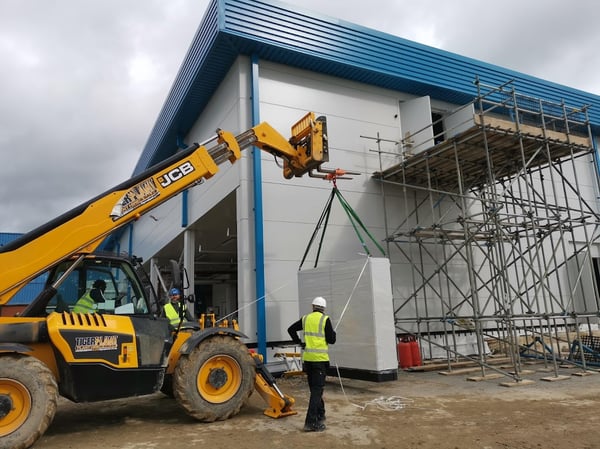 Pharma equipment being lifted onto a platform