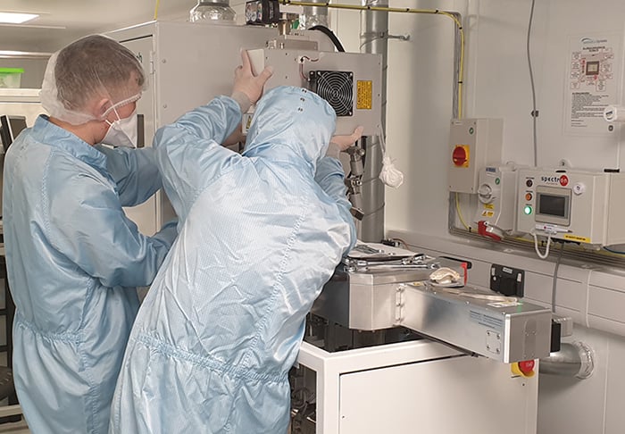 IES engineers working on equipment in a cleanroom