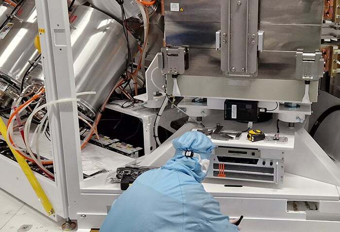 Field service engineer installing a semiconductor ion implanter