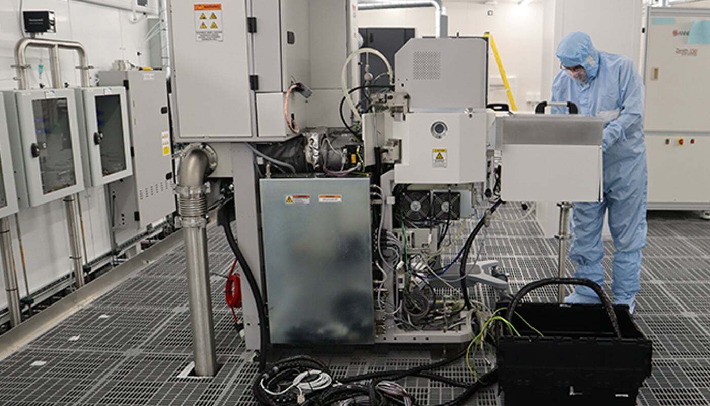 Engineers installing equipment in a clean manufacturing area